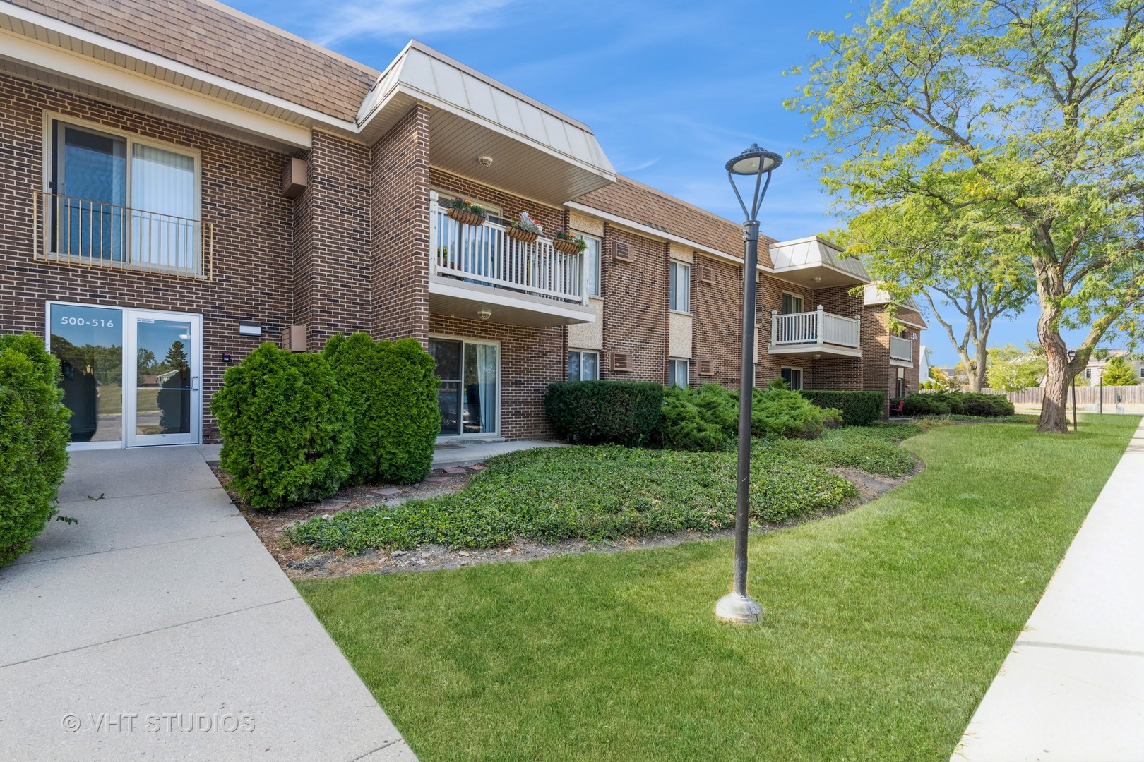 516 North Wilke Road, Unit 106 Palatine, IL 60074 - Photo 1 of 20 a house view with a garden space