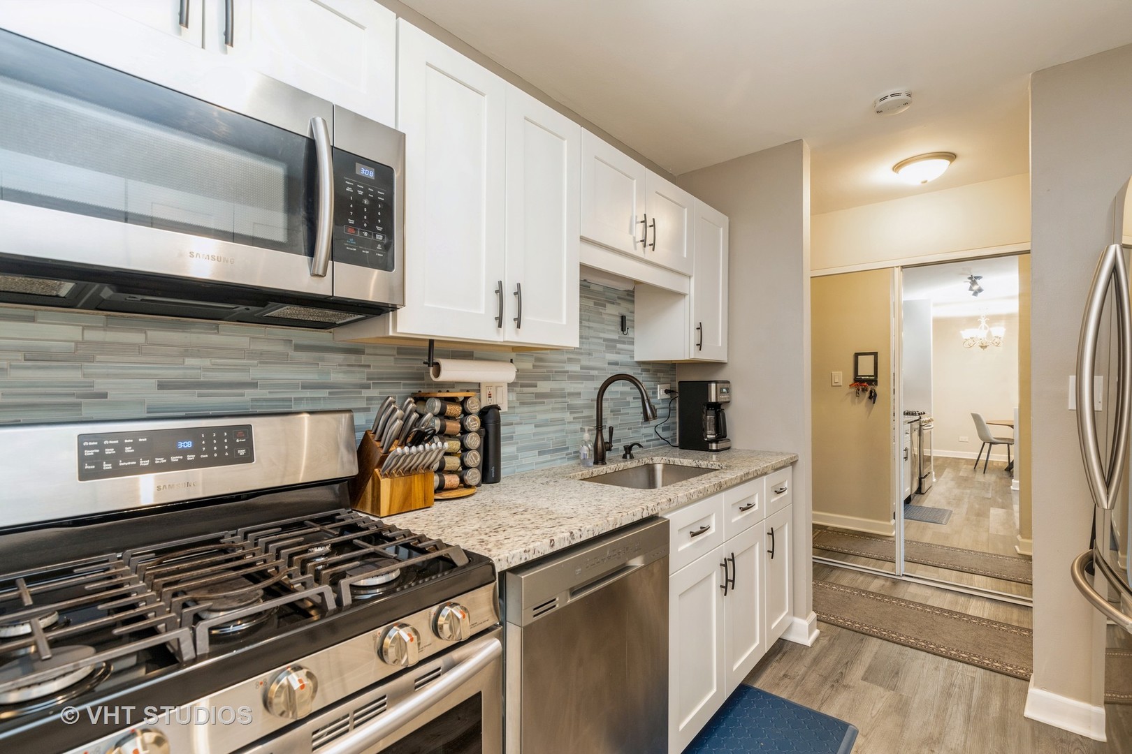 516 North Wilke Road, Unit 106 Palatine, IL 60074 - Photo 13 of 20 a kitchen with stainless steel appliances granite countertop a stove and a microwave