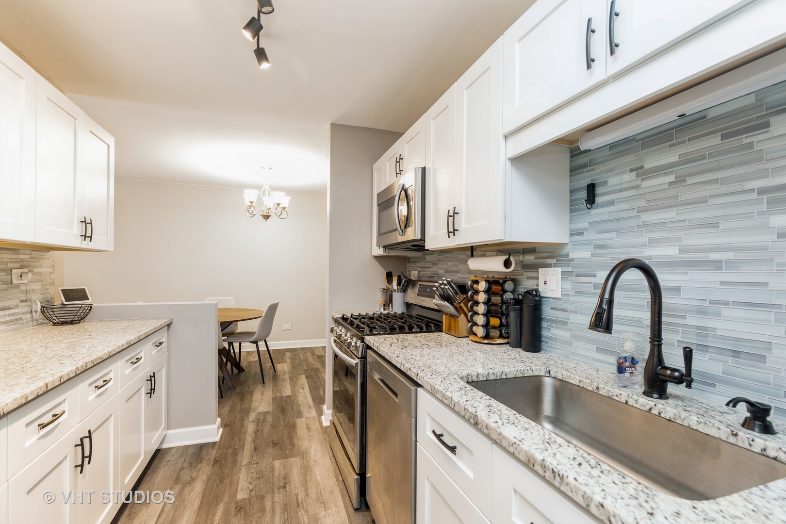 516 North Wilke Road, Unit 106 Palatine, IL 60074 - Photo 14 of 20 a kitchen with granite countertop a sink a counter space appliances and cabinets