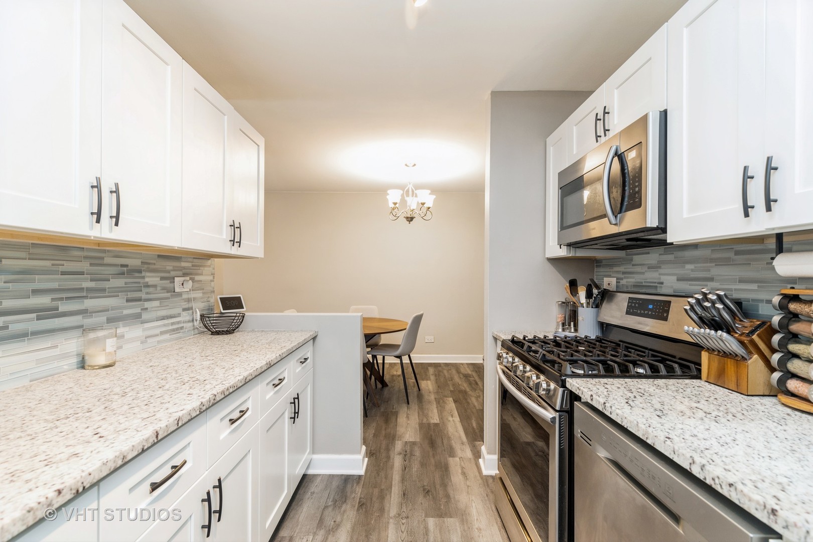 516 North Wilke Road, Unit 106 Palatine, IL 60074 - Photo 15 of 20 a kitchen with stainless steel appliances granite countertop a stove a sink and a microwave