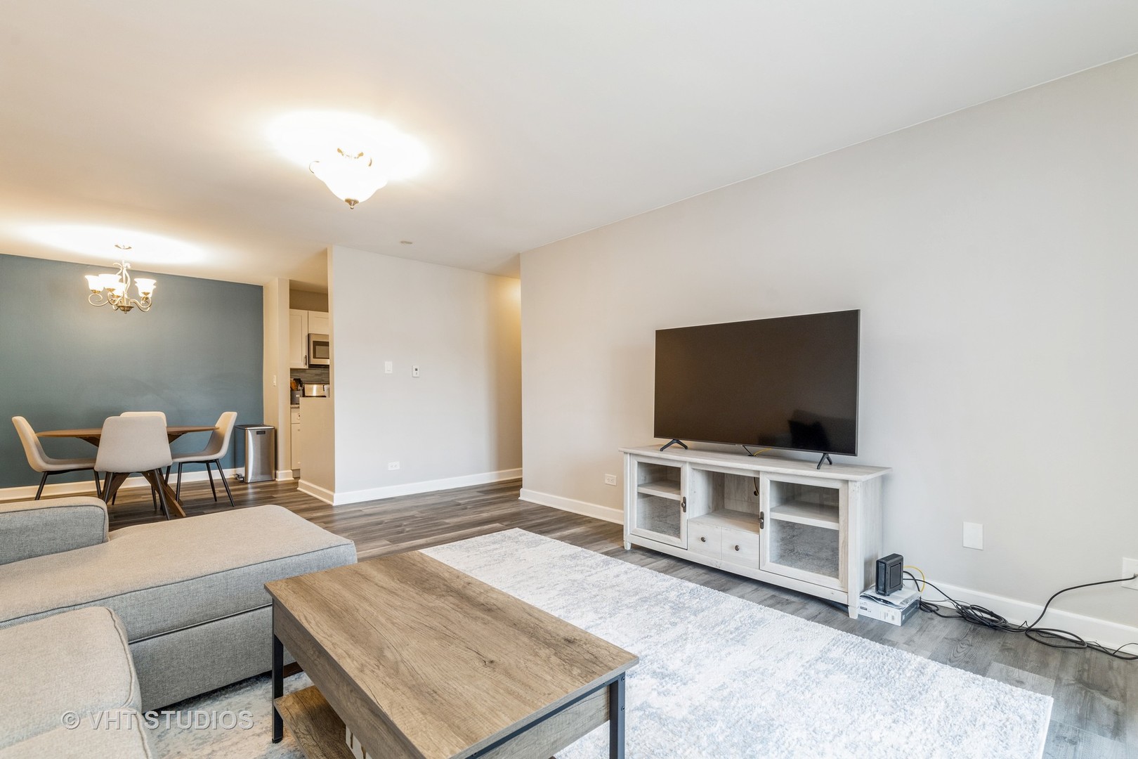 516 North Wilke Road, Unit 106 Palatine, IL 60074 - Photo 9 of 20 a living room with furniture and a flat screen tv