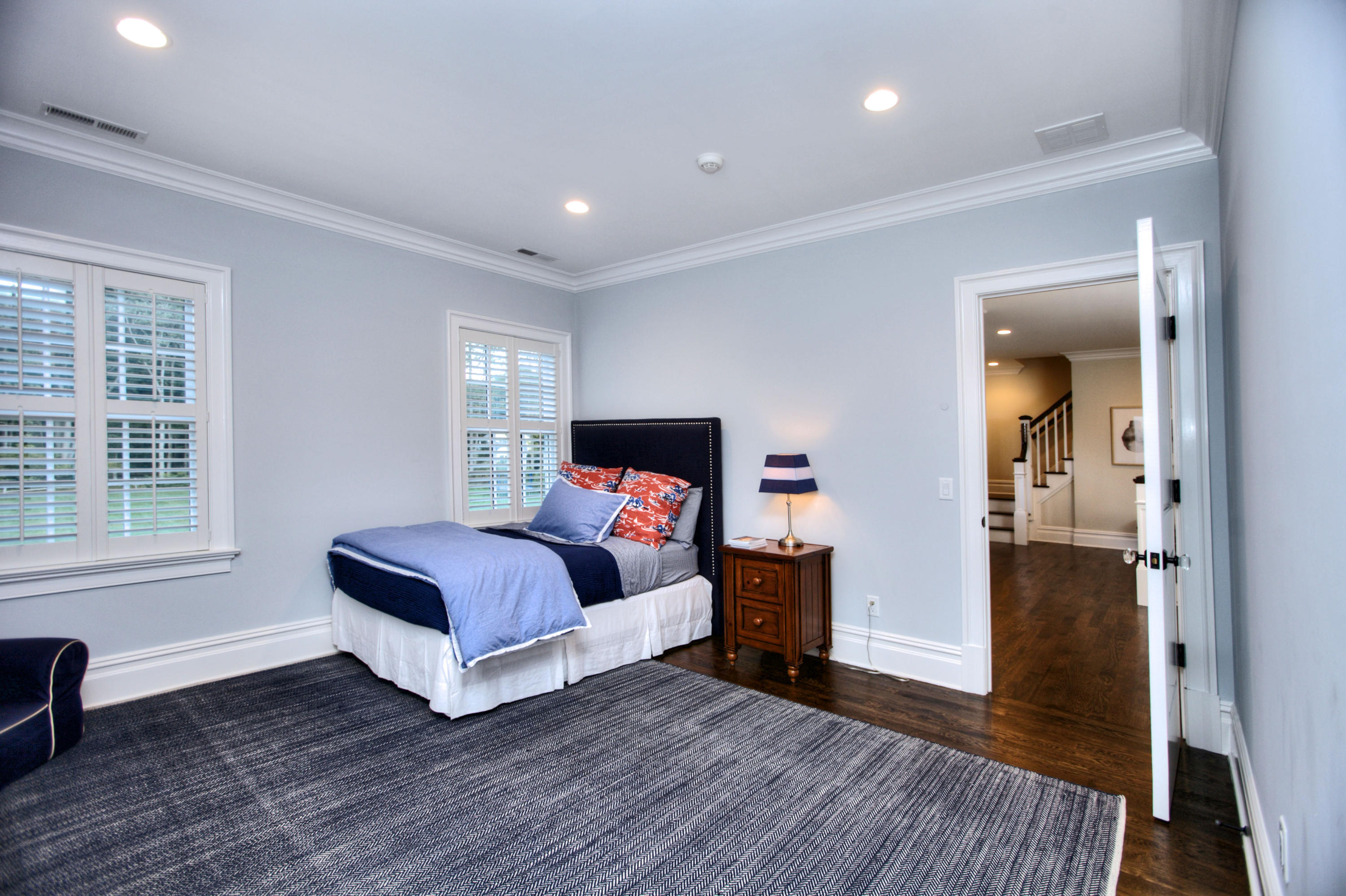 304 Brookside Road Darien, CT 06820 - Photo 16 of 25 a spacious bedroom with a bed and wooden floor