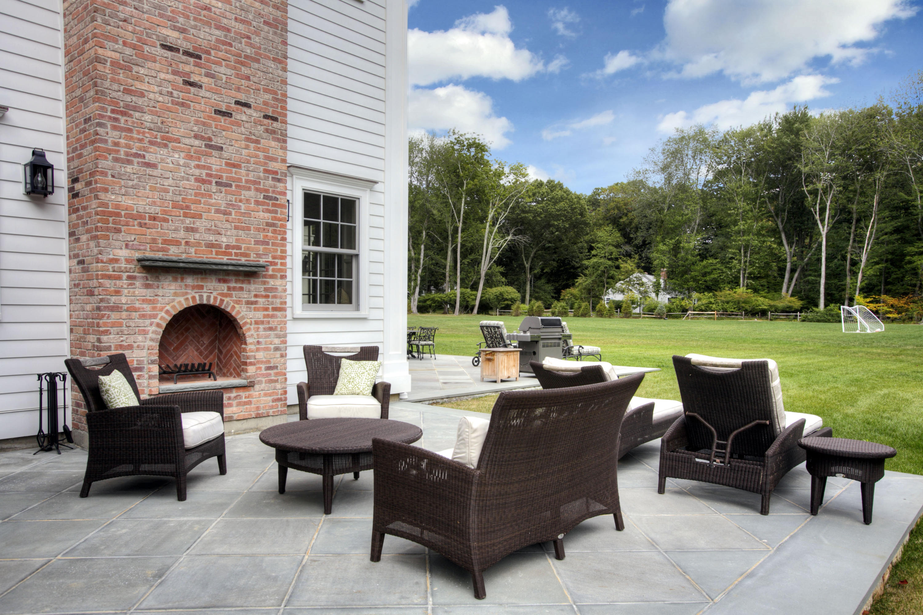 304 Brookside Road Darien, CT 06820 - Photo 23 of 25 a view of a patio with couches potted plants and a big yard