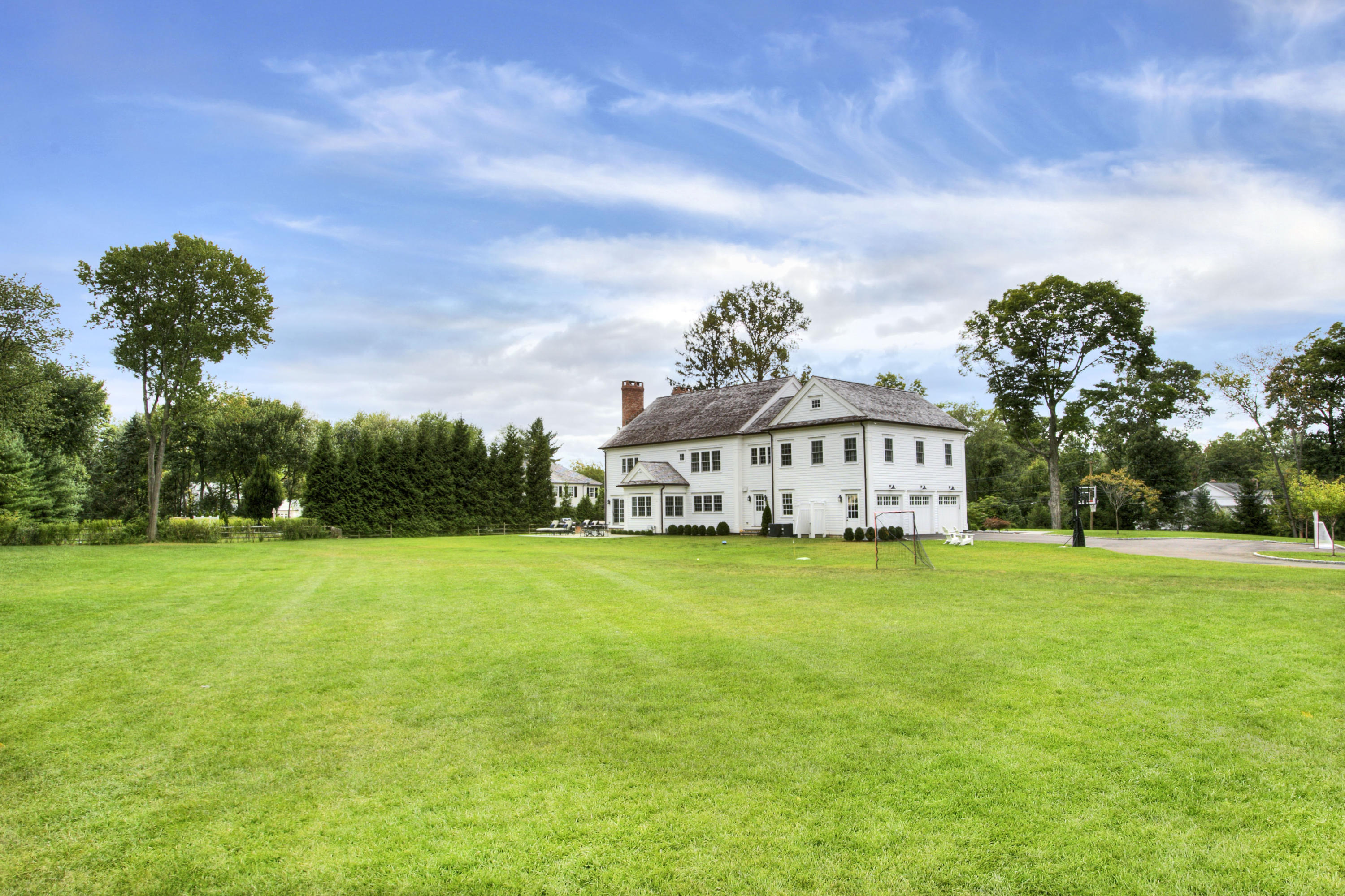 304 Brookside Road Darien, CT 06820 - Photo 25 of 25 a view of a big house with a big yard and large trees