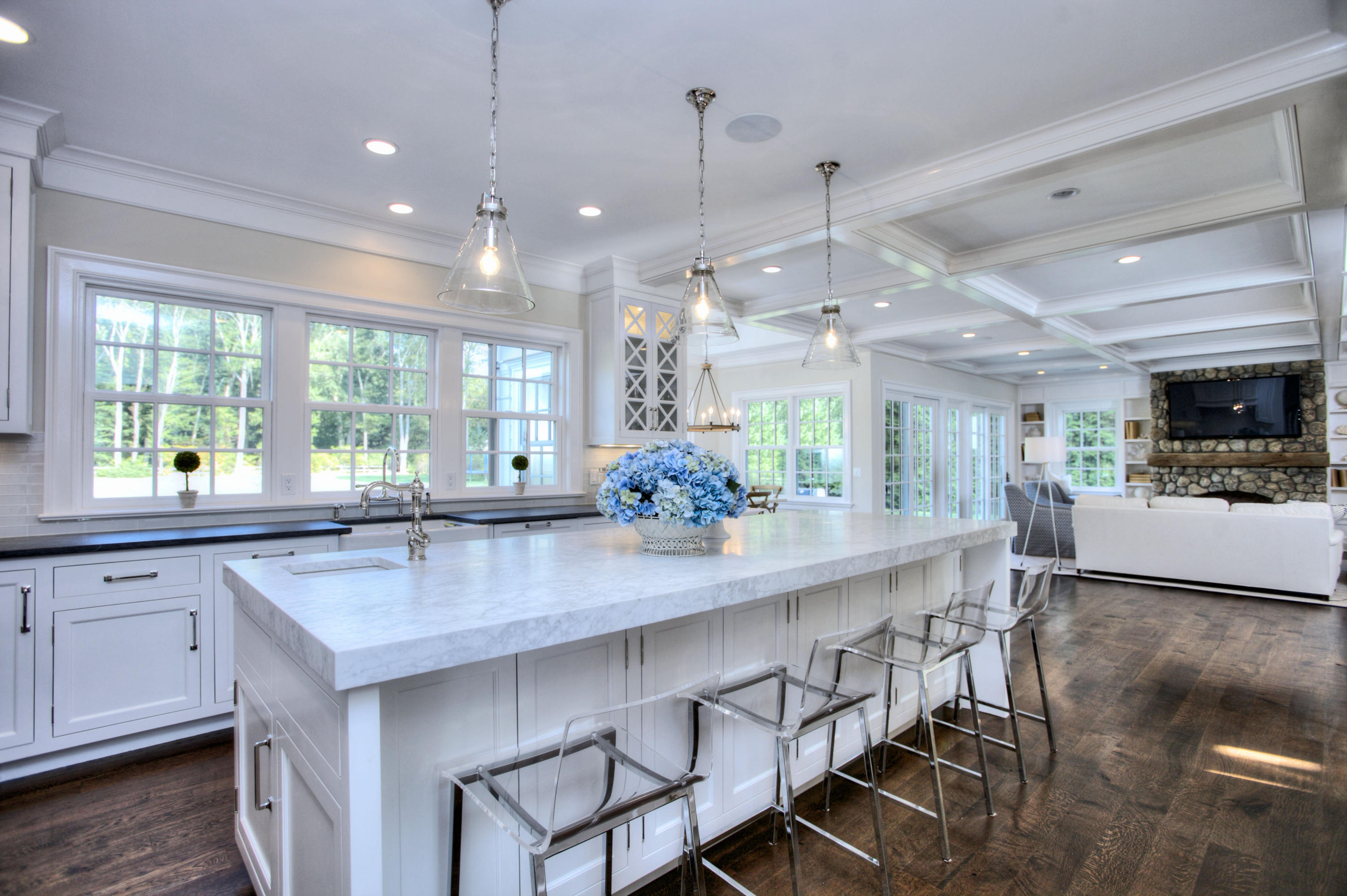 304 Brookside Road Darien, CT 06820 - Photo 6 of 25 a kitchen with kitchen island granite countertop a table and chairs in it