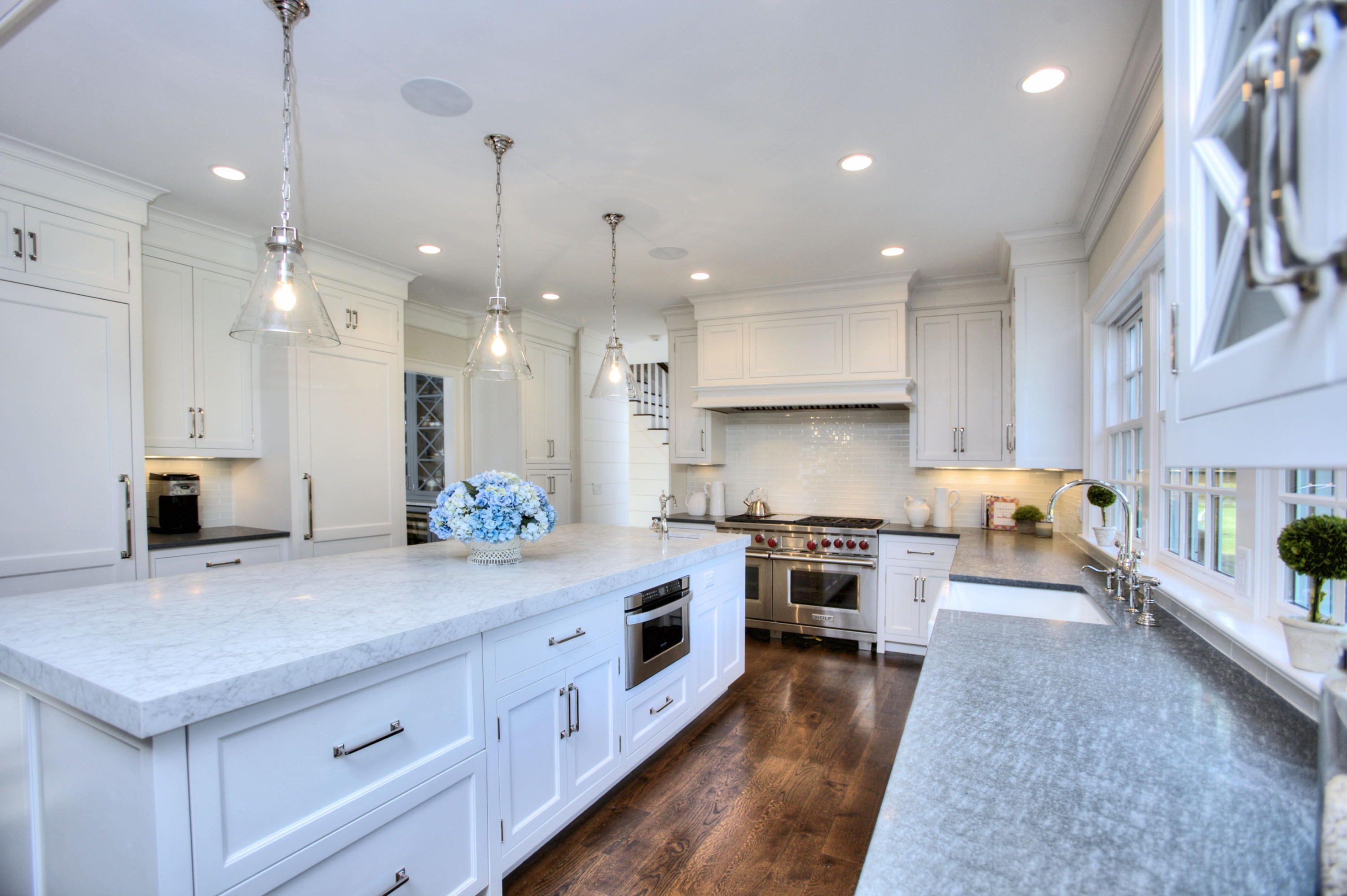304 Brookside Road Darien, CT 06820 - Photo 7 of 25 a large kitchen with stainless steel appliances lots of counter space and wooden floor