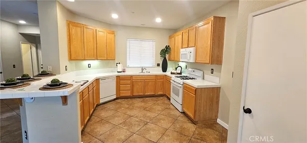 a view of a kitchen with a sink a window and stainless steel appliances