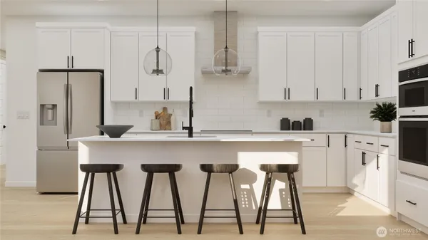 a kitchen with appliances cabinets and chair