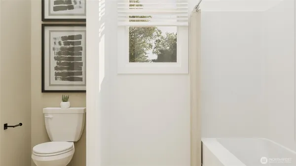 a white toilet sitting next to a bathroom sink