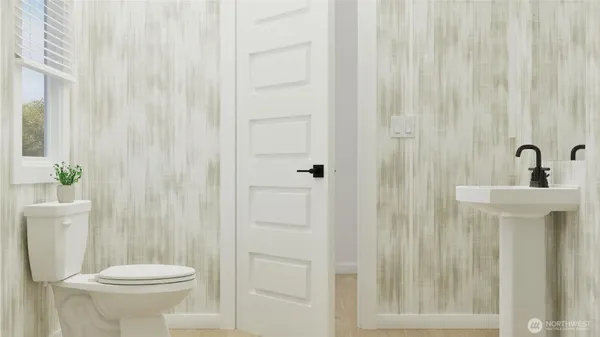 a bathroom with a sink a toilet a mirror and shower curtain