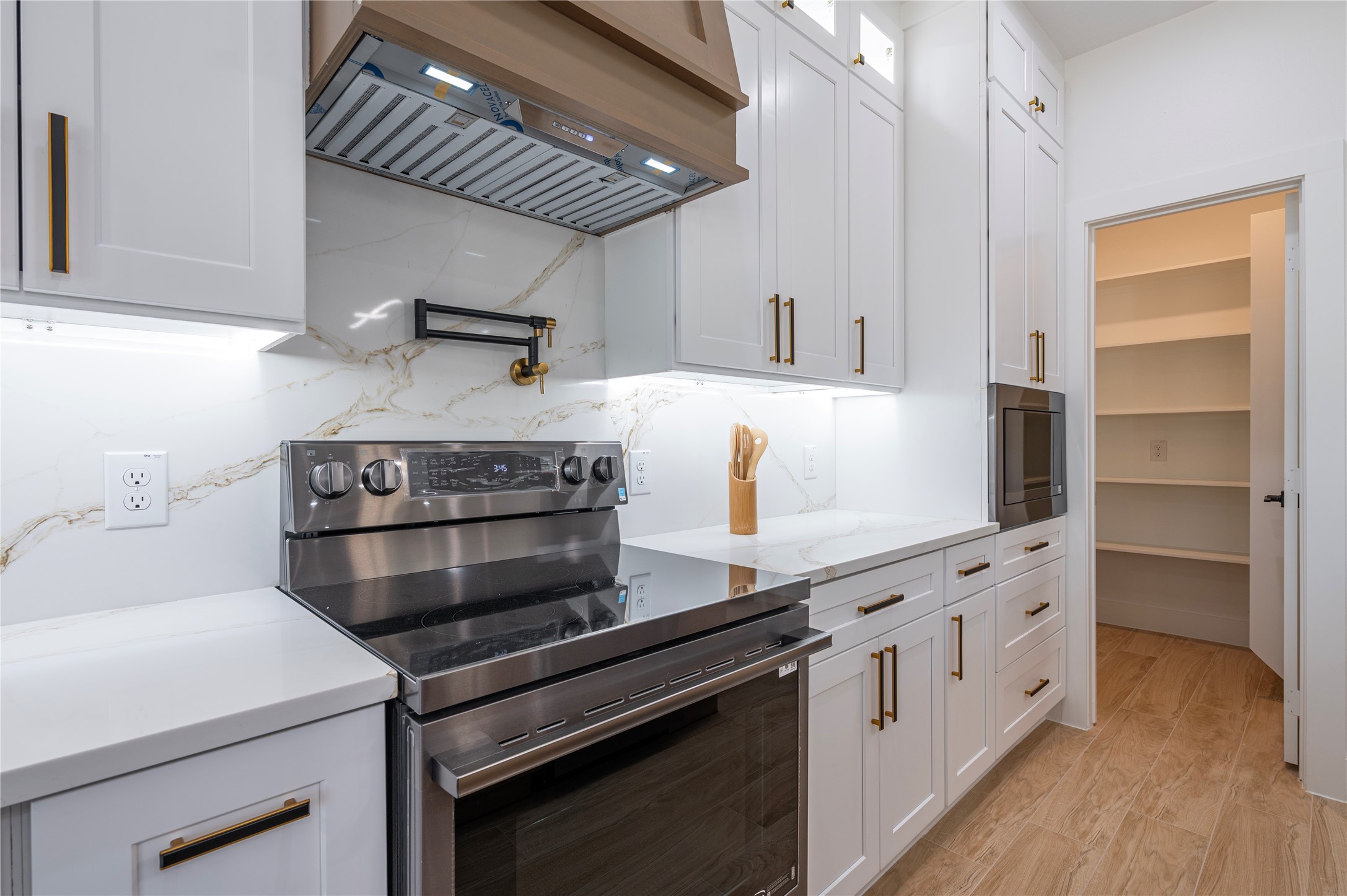 352 County Road 6490 Dayton, TX 77535 - Photo 17 of 45 a kitchen with appliances cabinets and a wooden floor