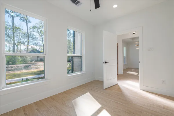 wooden floor in an empty room with a window