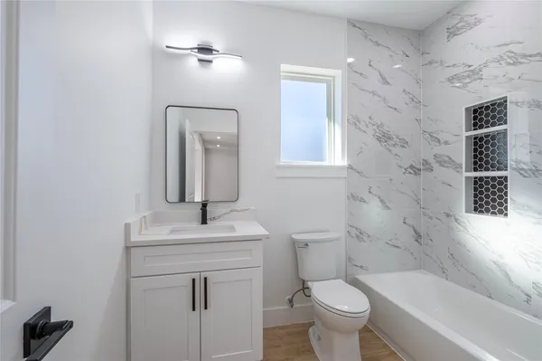 a bathroom with a sink toilet and shower