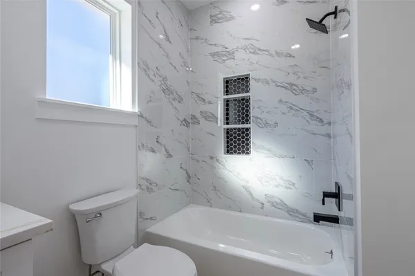 a bathroom with a toilet and a bathtub