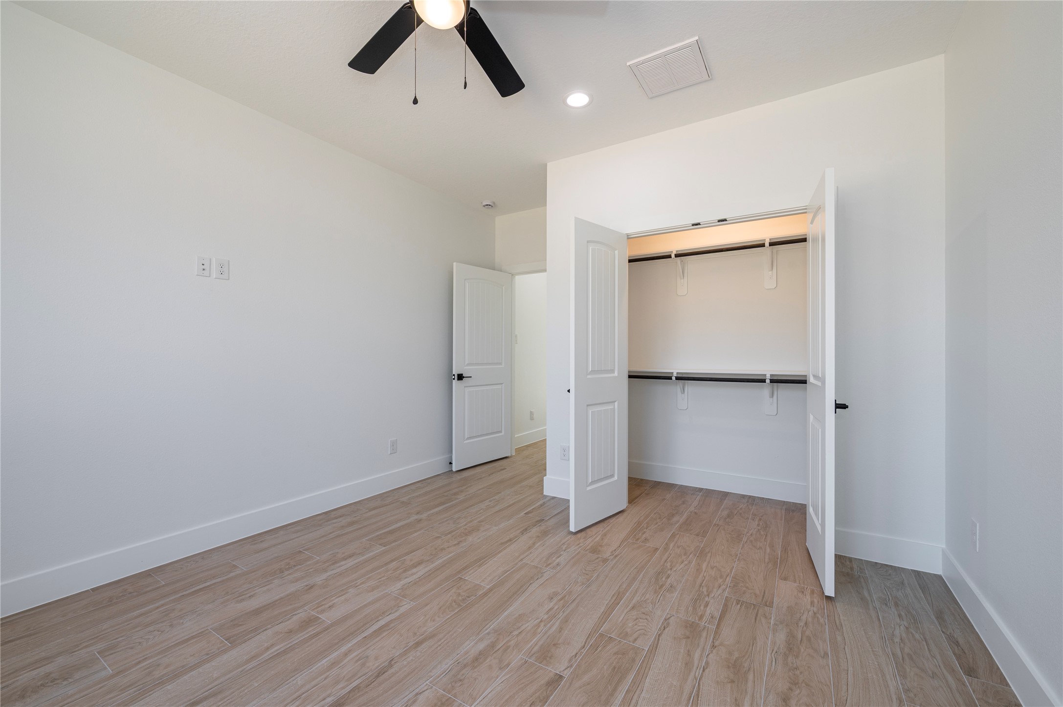 352 County Road 6490 Dayton, TX 77535 - Photo 26 of 45 an empty room with wooden floor and a ceiling fan
