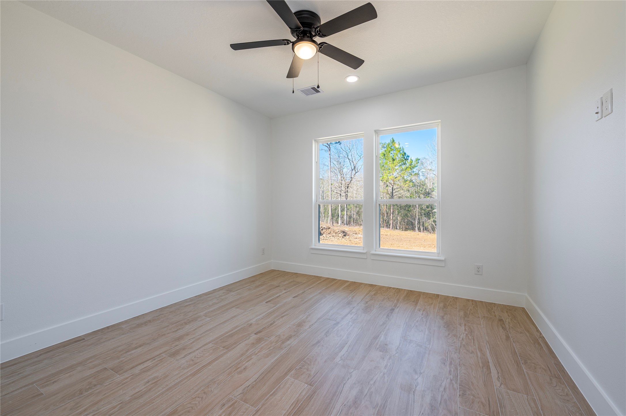 352 County Road 6490 Dayton, TX 77535 - Photo 27 of 45 wooden floor in an empty room with a window