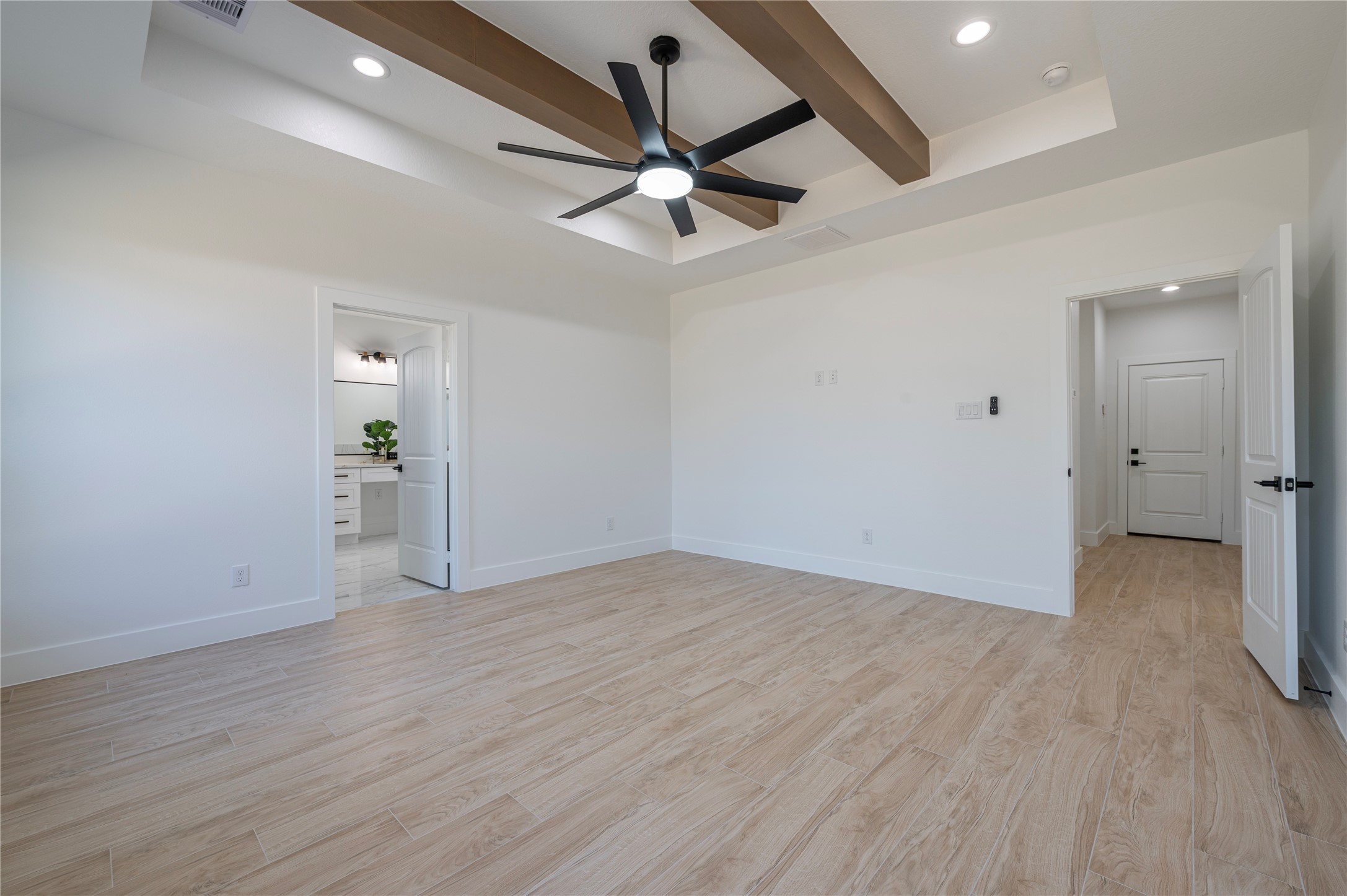352 County Road 6490 Dayton, TX 77535 - Photo 29 of 45 an empty room with wooden floor ceiling fan and windows