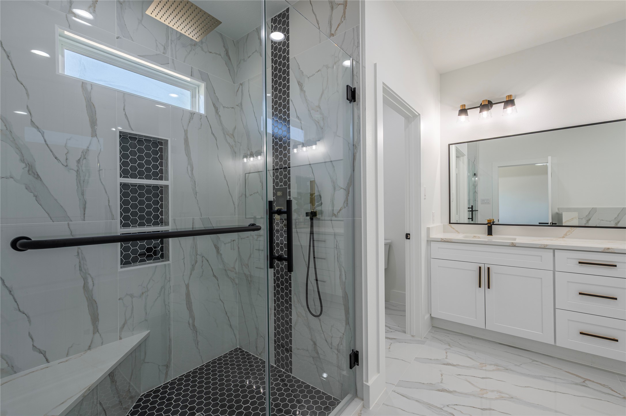 352 County Road 6490 Dayton, TX 77535 - Photo 32 of 45 a bathroom with a sink a toilet a mirror and shower