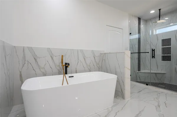 a bathroom with a bathtub and a shower