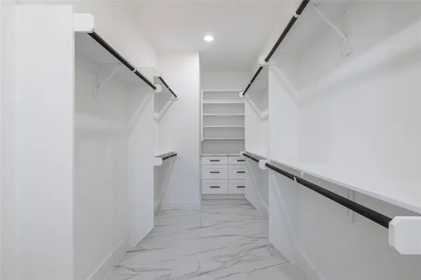 a view of walk in closet with stairs