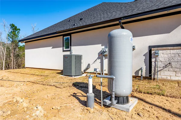 a backyard of a house with table and chairs