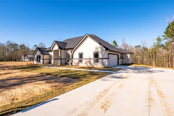 a view of a house with snow on the road