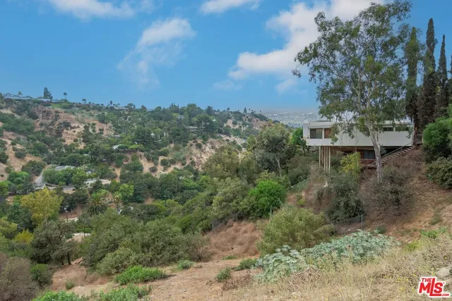 a view of a city with green field