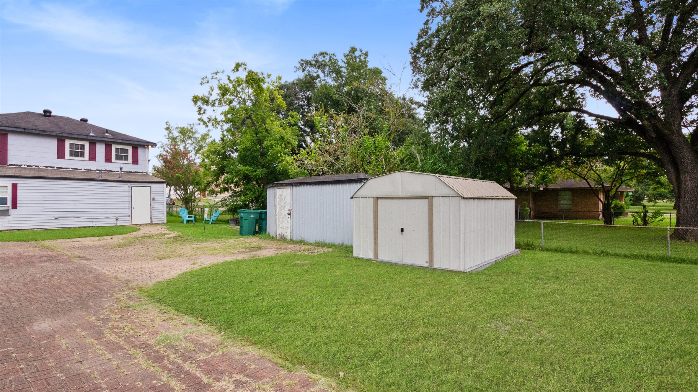 317 West Lewis Street Conroe, TX 77301 - Photo 15 of 30 a view of a house with a yard and large tree