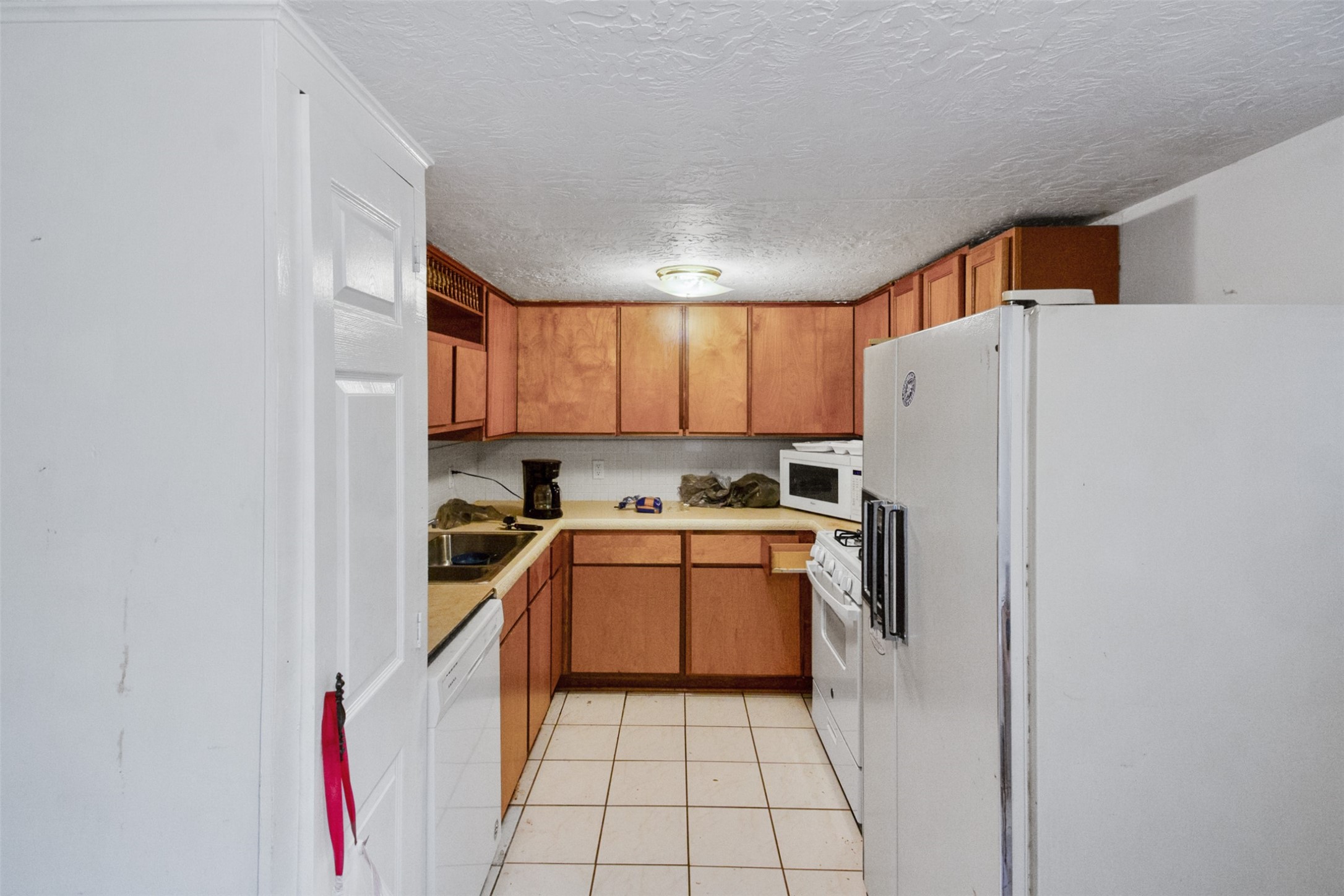 317 West Lewis Street Conroe, TX 77301 - Photo 19 of 30 a kitchen with a white cabinets and white appliances