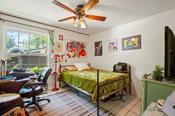 a bedroom with two beds and a chandelier