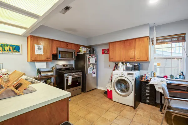 a utility room with sink dryer and washer