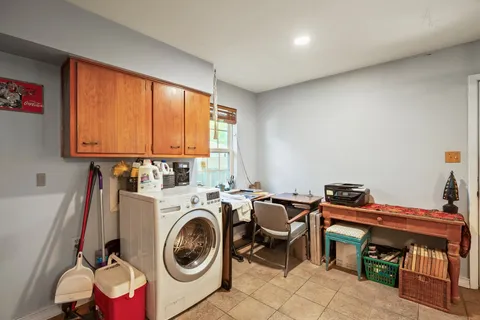 a utility room with dryer washer and a window