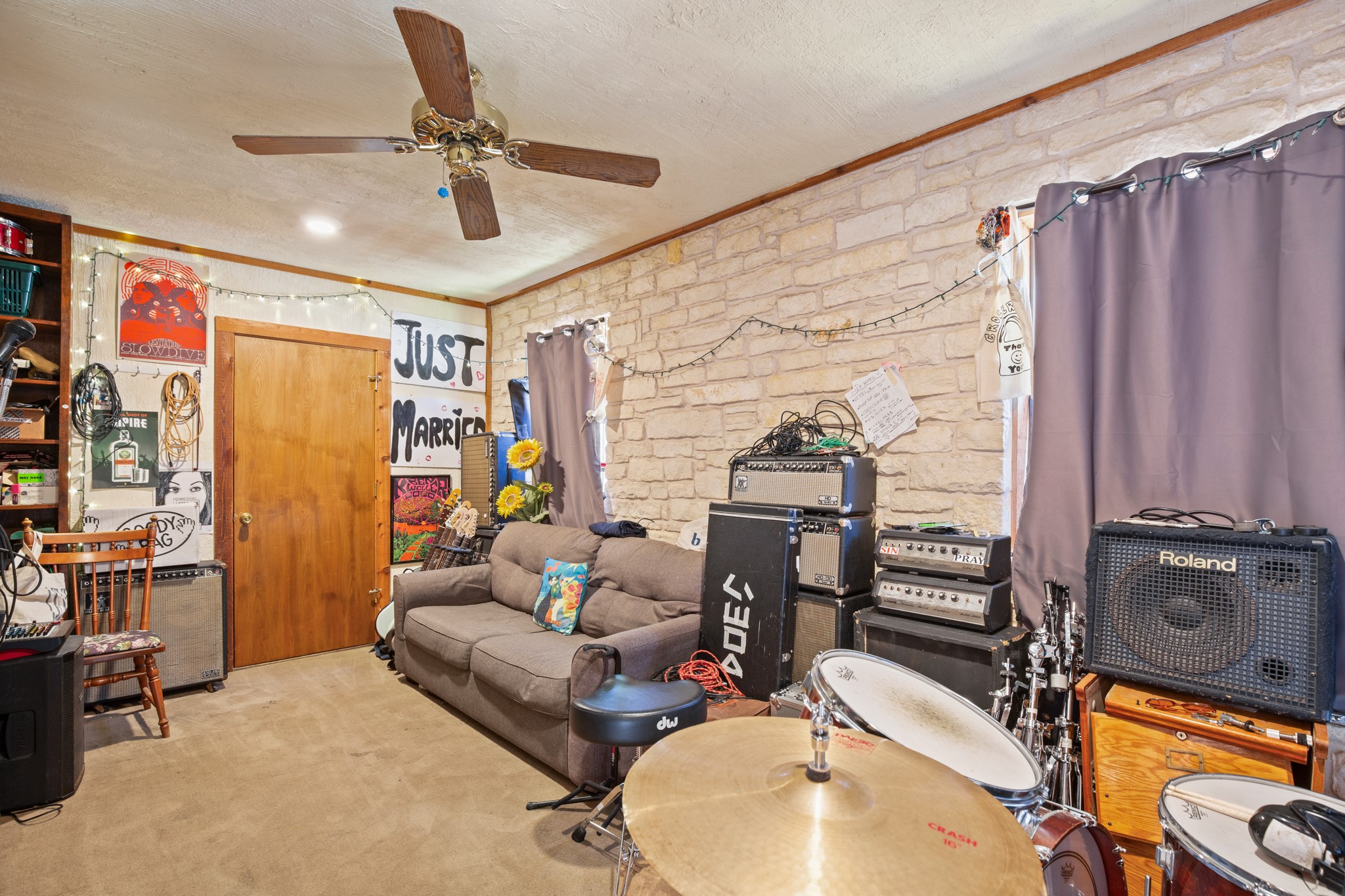 4606 South 2nd Street Austin, TX 78745 - Photo 21 of 24 Living room featuring a textured ceiling, ceiling fan, ornamental molding, and carpet flooring