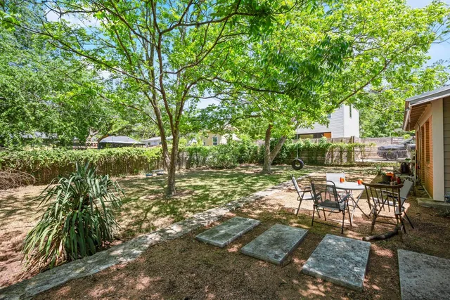 a view of backyard with seating area and green space