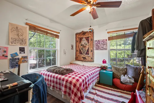 a bedroom with a bed and a window