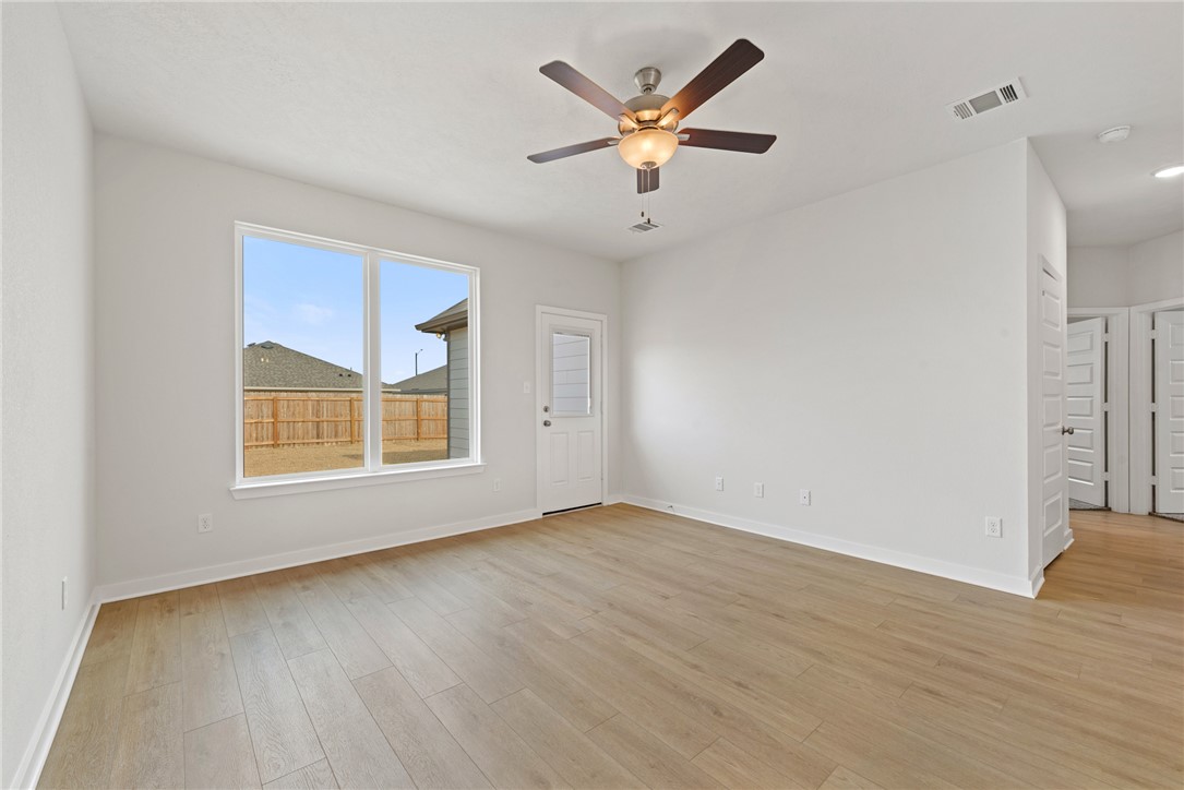 2412 Rooke Road Bryan, TX 77807 - Photo 18 of 35 an empty room with wooden floor and windows