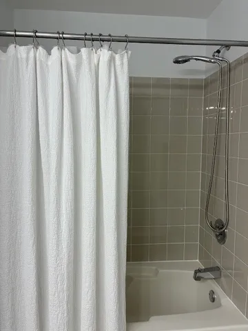 a bathroom with a shower and a tub