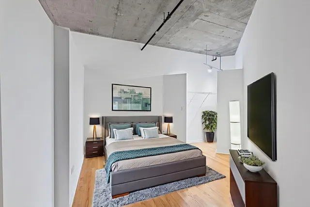 a bedroom with a bed and a flat screen tv