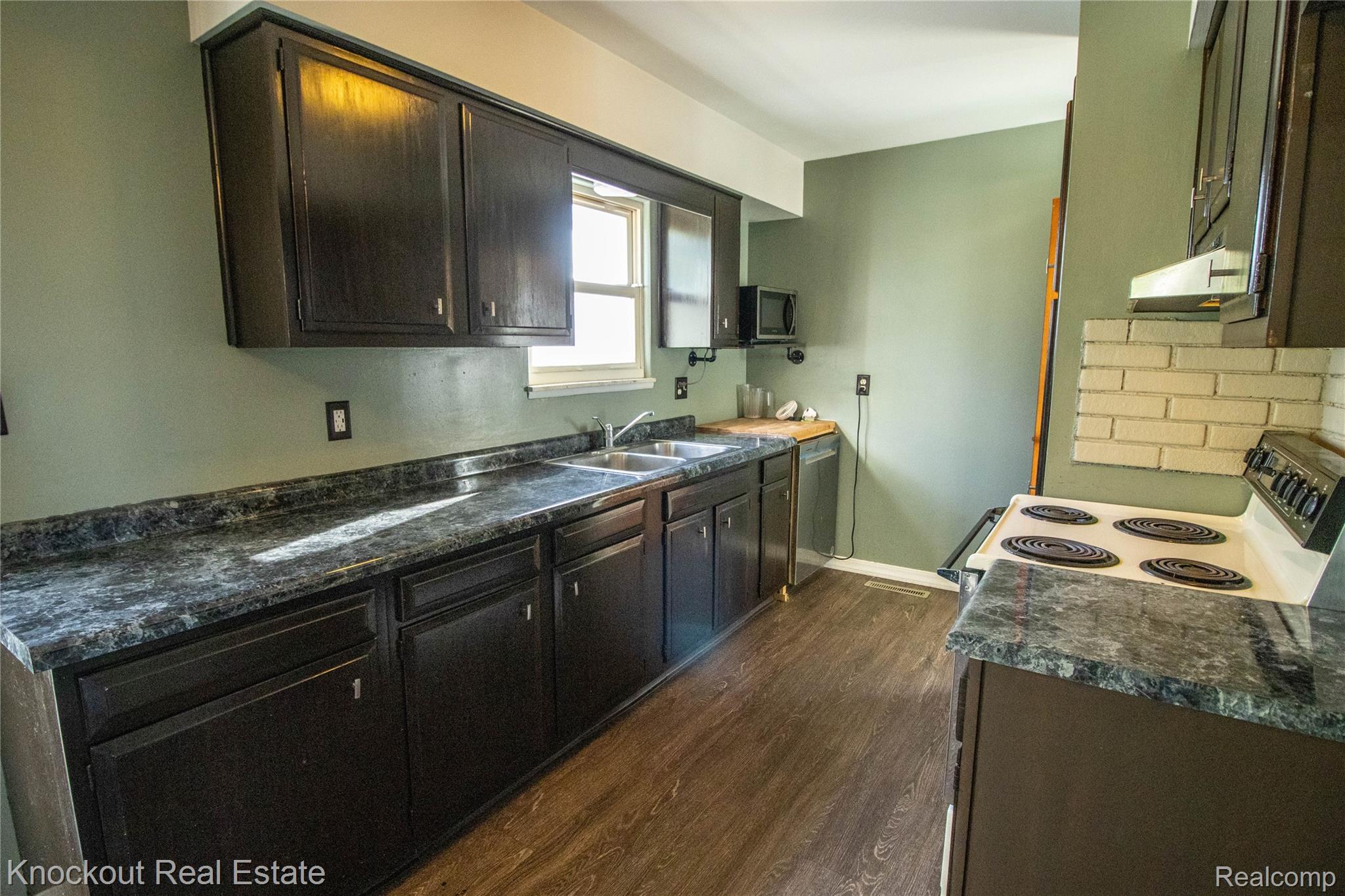 5796 East Burt Road Birch Run, MI 48415 - Photo 9 of 41 Dark-finish cabinetry paired with dark-toned countertops