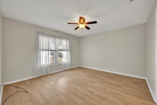 a bathroom with a toilet sink vanity granite and shower