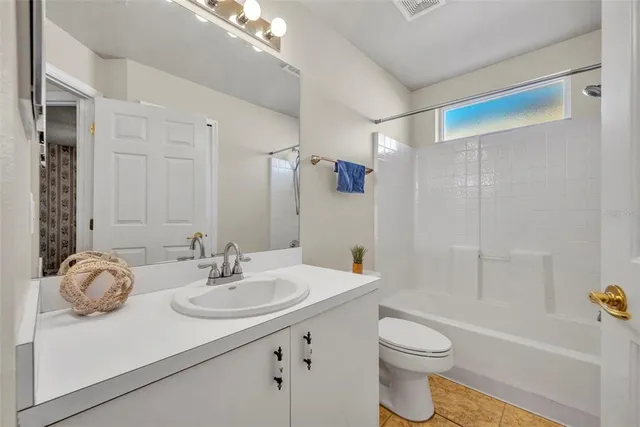 a view of house with yard and palm trees