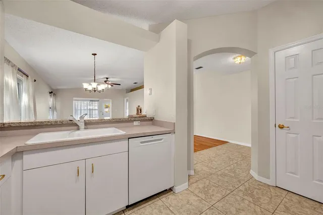 a view of kitchen with stainless steel appliances granite countertop refrigerator sink and stove