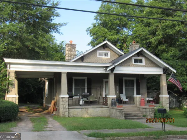 a front view of house with yard and outdoor seating