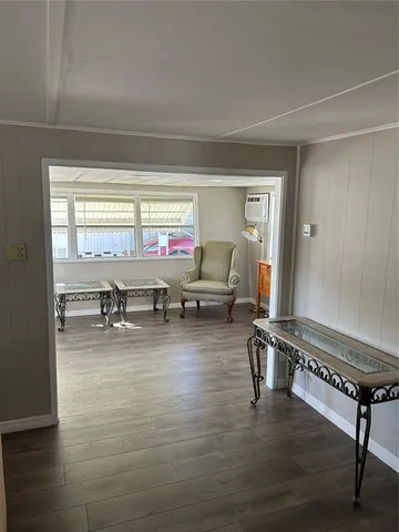 a room with wooden floor and furniture