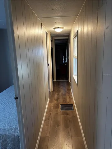 a view of a hallway with wooden floor