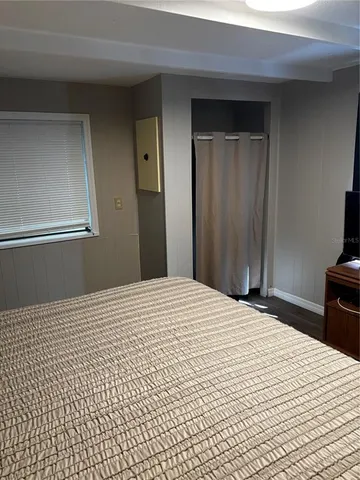 a bedroom with a bed and a mirror