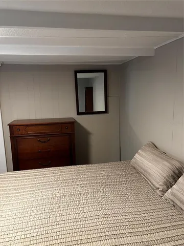 a bedroom with a bed and a lamp