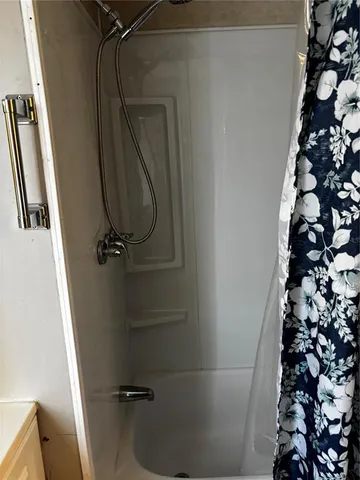 a bathroom with a toilet a sink and a shower curtain