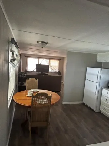 a view of a dining room with furniture and window