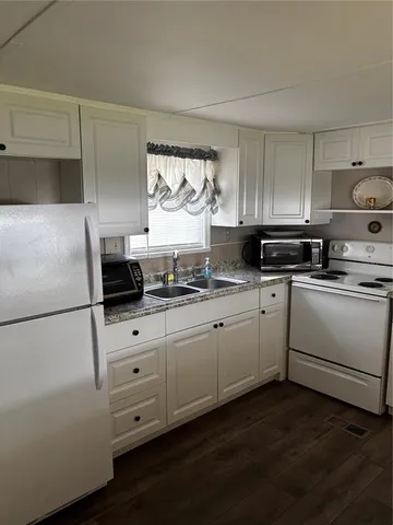 a kitchen with appliances cabinets and a sink